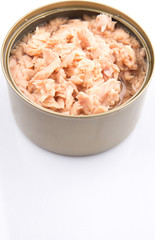 Pieces of tuna fish in a tin can over white background
