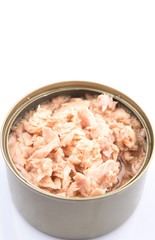 Pieces of tuna fish in a tin can over white background