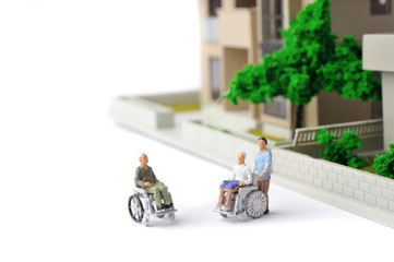 車椅子生活をしている高齢者と住宅街