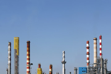 Smoke stacks against blue sky