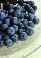 Ripe blueberries on a plate.