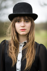 Beautiful Young Woman Dressed In Black Wearing Bowler Hat