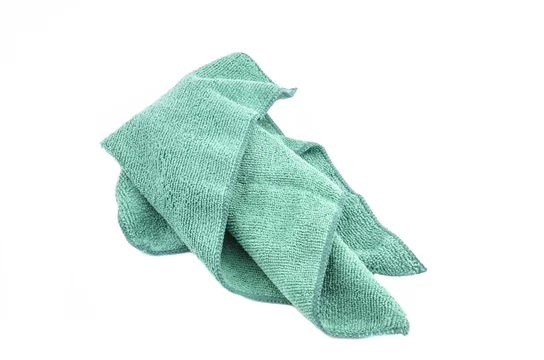 Crumpled green microfiber cloth isolated on white background