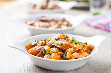 Gnocchi di patate conditi con sugo rosso e funghi porcini