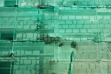 Construction scaffolding and green debris netting abstract backg