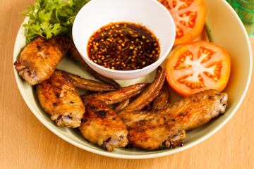 Grilled chicken wings on dish.