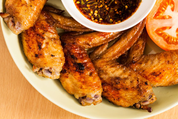 Grilled chicken wings on dish.