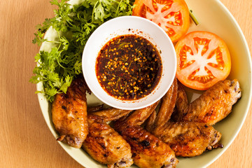 Grilled chicken wings on dish.