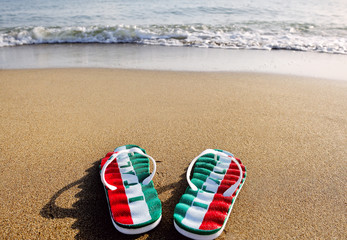 flip flops on beach sand - holidays and relaxation concept
