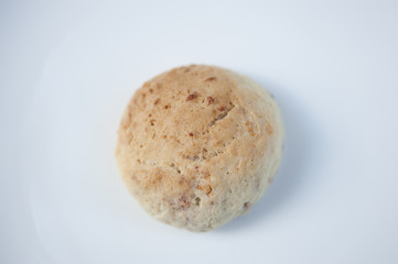 A handmade strawberry cookie on a white background.