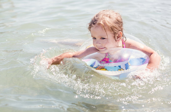 Happy little girl  bathing in sea