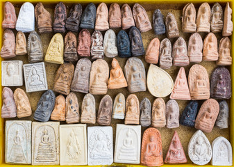 small buddha image used as amulet - obrazy, fototapety, plakaty