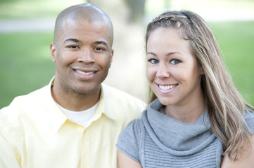 Fototapeta premium Happy young interracial couple posing together on a sunny day.