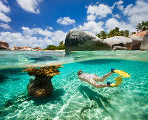 Woman snorkeling in tropical water - obrazy, fototapety, plakaty