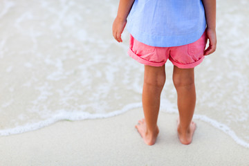 Close up of little girl standing at beach