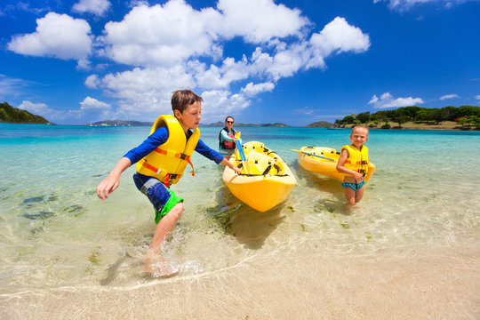 Family Kayaking At Tropical Ocean