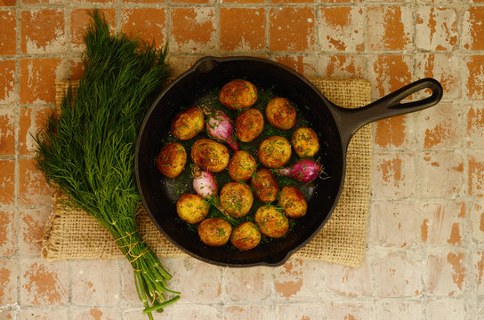 Whole baked young potato and young oinion and bunch of fresh dil