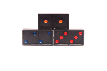 Domino row closeup with first one in focus on white background