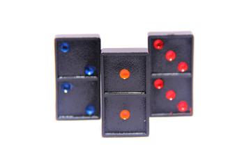 Domino row closeup with first one in focus on white background