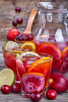 Ice refreshing summer drink with lots of different fruits