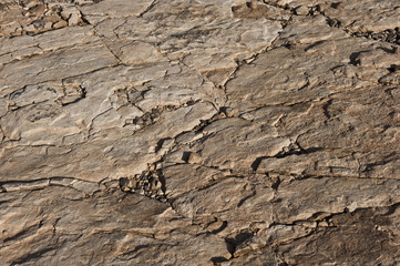 Naklejka premium A dry desert view on a sunny day from a helicopter.