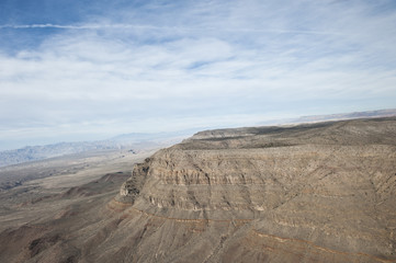 A dry desert view on a sunny day from a helicopter.