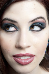 A closeup on the model's makeup in a studio.