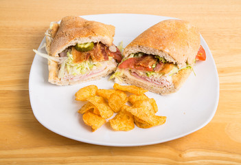 Sub Sandwich on Plate with Bacon and Potato Chips