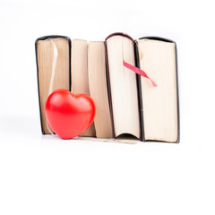 Books with heart on white isolated background