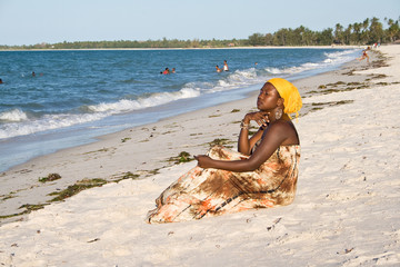 African woman looking interested to the sea.