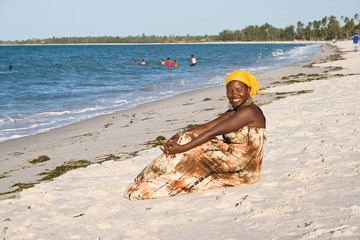 Happy African woman enjoying the beach.