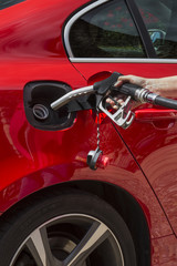Fototapeta premium Pumping Gas - Filling a car with fuel