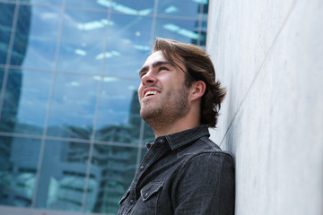 Profile of a young man smiling outside