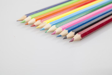 Bunch of color pencils over a white background