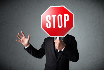 Businessman holding a stop sign