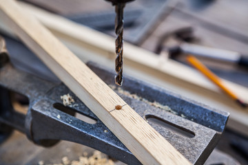 Old electric drill press with drill bits for wood
