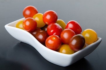Cup of different varieties of cherry tomatoes