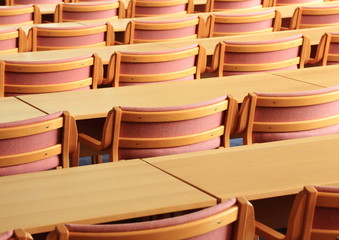Empty conference room with wooden chairs facing rear