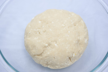 Fototapeta na wymiar Handmade cookie dough in a glass bowl on a sunny day.