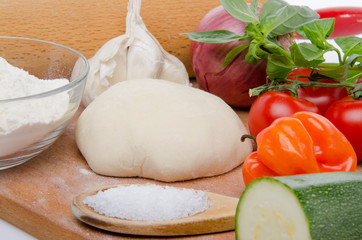 Different ingredients to make a pizza