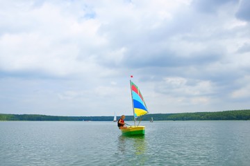 Sailing, Girl flows in a sailboat on the lake