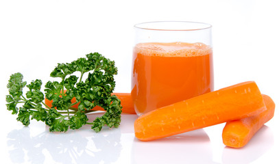 Composition with a glass of carrot juice, fresh carrots and pars