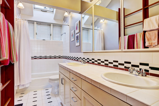 White bathroom with tile wall trim