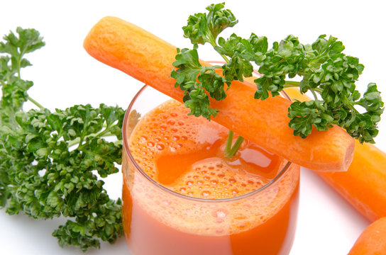 Composition with a glass of carrot juice, fresh carrots and pars