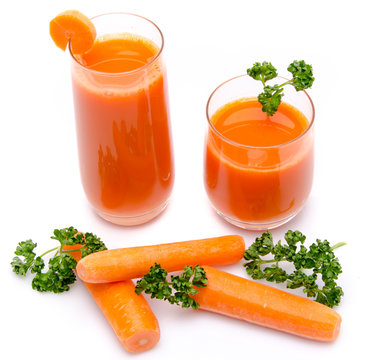 Composition with two glasses of carrot juice, fresh carrots and