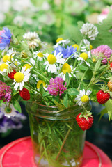 Bouquet of wild flowers and strawberries