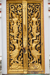 Traditional Thai style carving and painting art at the temple