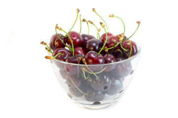 A glass bowl of cherries