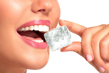Closeup of beautiful woman biting an ice cube