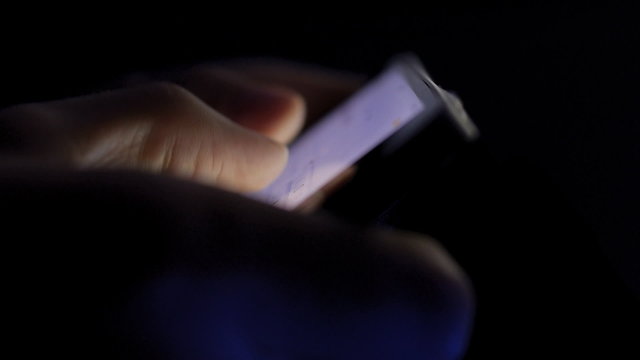 Businessman typing note on the iPhone touch screen